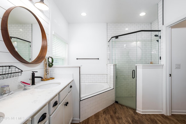 95220 Snapdragon Dr, Fernandina Beach, FL 32034 - full bathroom featuring a shower stall, a garden tub, recessed lighting, wood finished floors, and vanity