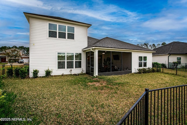 95220 Snapdragon Dr, Fernandina Beach, FL 32034 - rear view of property featuring a sunroom, a lawn, a shingled roof, and a fenced backyard