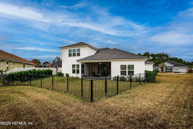 95220 Snapdragon Dr, Fernandina Beach, FL 32034 - back of house with roof with shingles, a fenced backyard, a sunroom, and a lawn