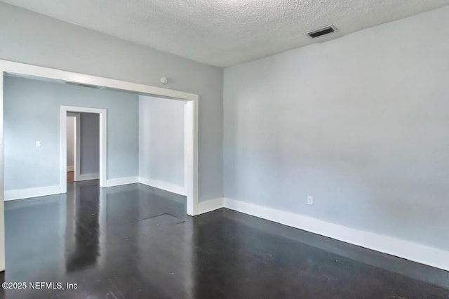 spare room with a textured ceiling