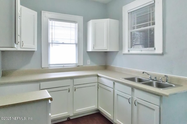 kitchen featuring sink and white cabinets