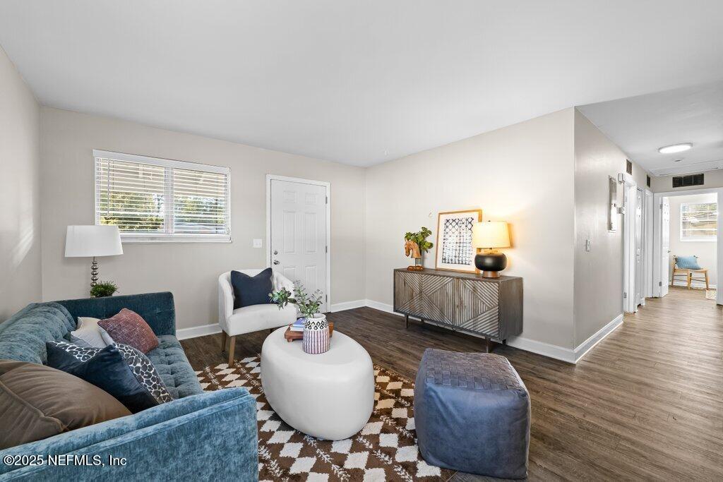 living room with dark hardwood / wood-style flooring