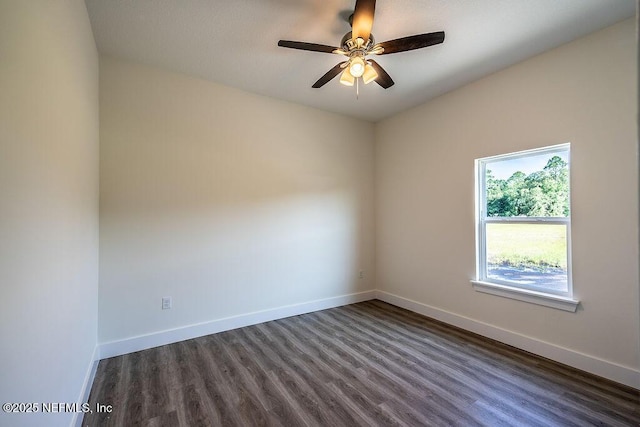 spare room with ceiling fan and dark wood-type flooring