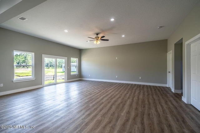 unfurnished room featuring a textured ceiling, ceiling fan, and dark wood-type flooring