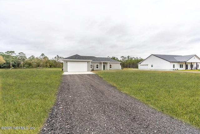 ranch-style house featuring a garage and a front yard