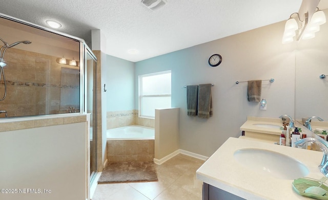 bathroom featuring tile patterned flooring, vanity, plus walk in shower, and a textured ceiling