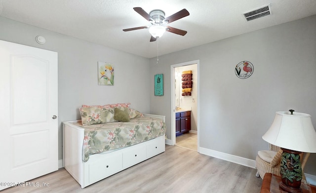 bedroom with ceiling fan, light wood-type flooring, and ensuite bathroom