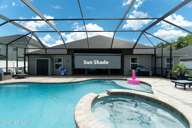 view of pool with a lanai and an in ground hot tub