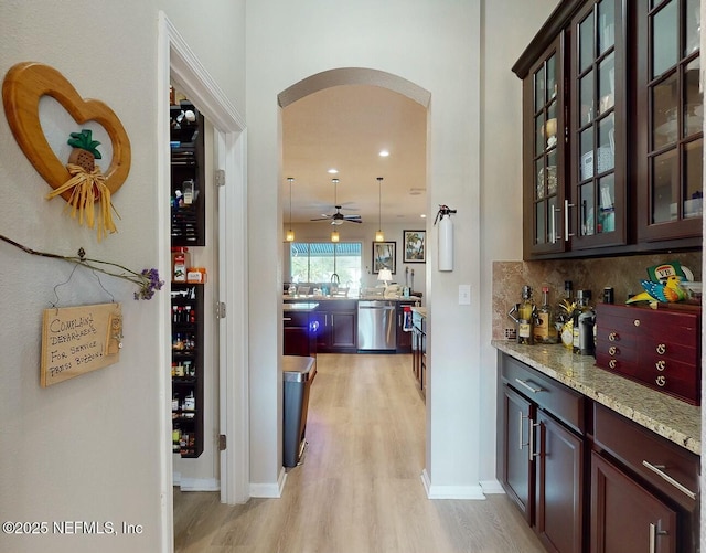 corridor with light hardwood / wood-style floors