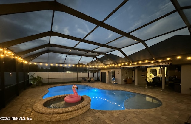 view of swimming pool with a jacuzzi, a patio area, and glass enclosure