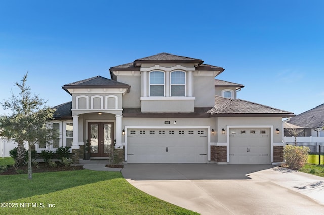 mediterranean / spanish-style house with a front yard and a garage