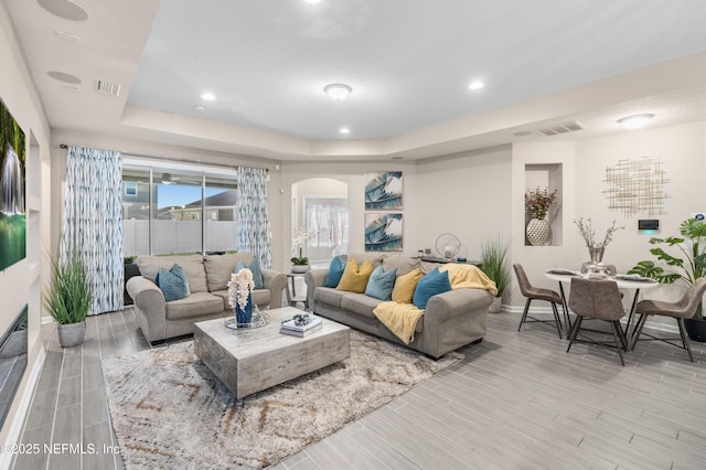 living room with a tray ceiling