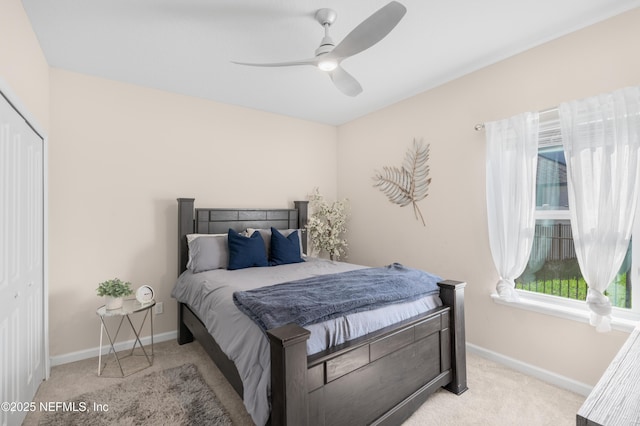 carpeted bedroom featuring a closet and ceiling fan