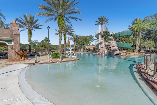 view of swimming pool featuring a patio and a water slide