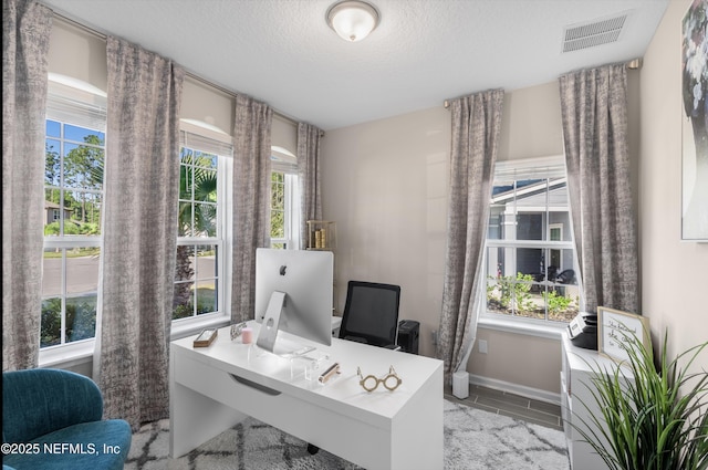 office area with a textured ceiling and plenty of natural light