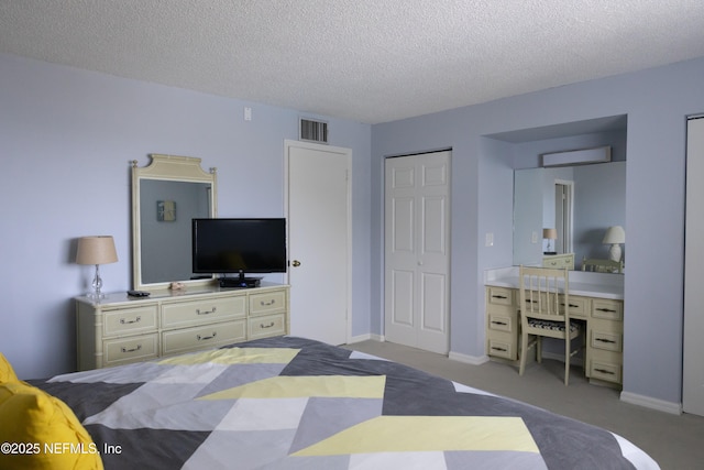 carpeted bedroom featuring a closet and a textured ceiling