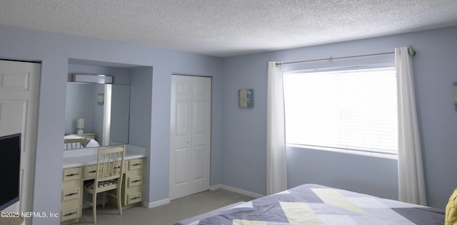 carpeted bedroom with multiple windows and a textured ceiling