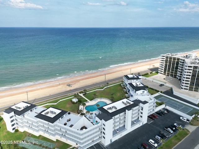 birds eye view of property with a view of the beach and a water view