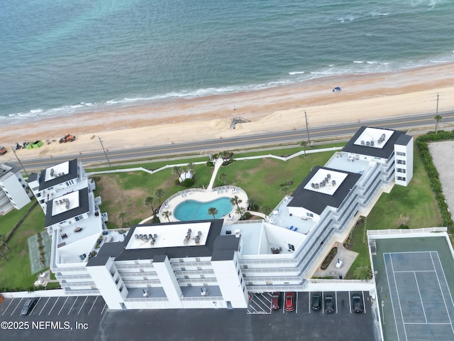 birds eye view of property with a water view and a view of the beach