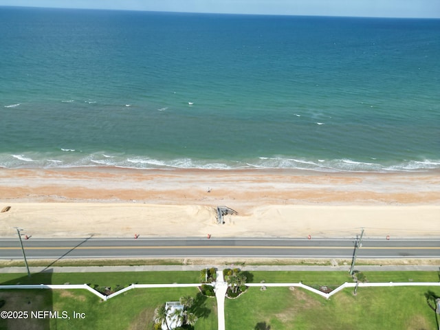 birds eye view of property with a view of the beach and a water view