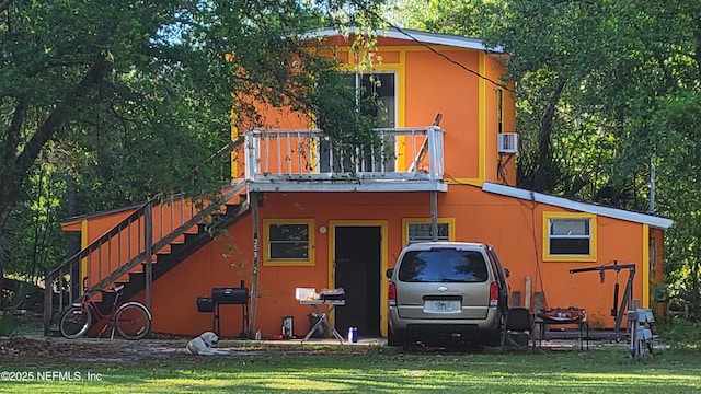 back of house with a yard and cooling unit