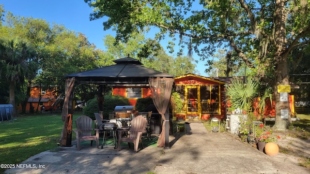 view of patio with a gazebo and a sunroom