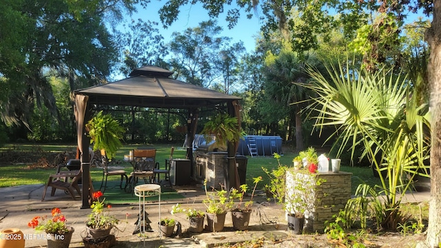 view of patio / terrace with a gazebo and an outdoor kitchen