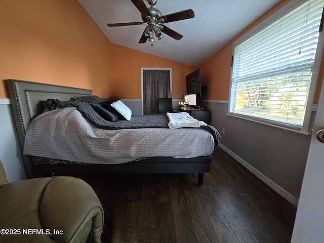 bedroom featuring a textured ceiling, ceiling fan, wood-type flooring, and vaulted ceiling