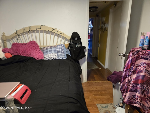 bedroom with hardwood / wood-style flooring