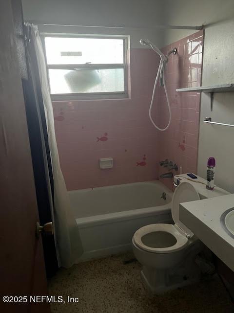 bathroom with toilet and shower / tub combo with curtain