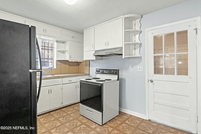 kitchen featuring black fridge, white electric range oven, backsplash, and white cabinetry