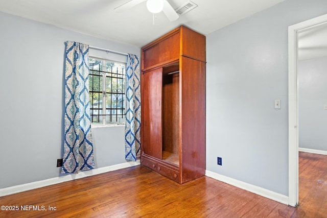 unfurnished bedroom featuring a closet, ceiling fan, and wood-type flooring