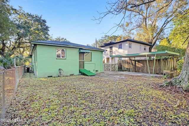 rear view of property with central AC unit