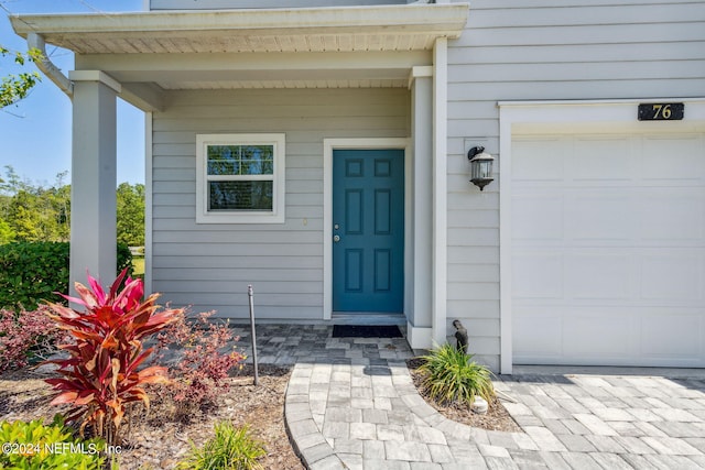 doorway to property with a garage