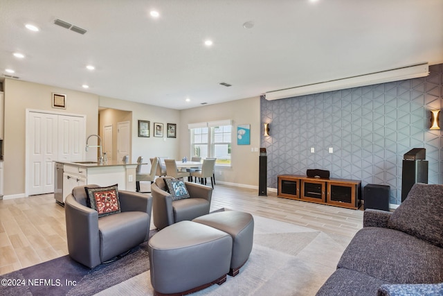 living room featuring light hardwood / wood-style floors and sink