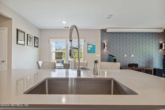 kitchen with sink and tasteful backsplash