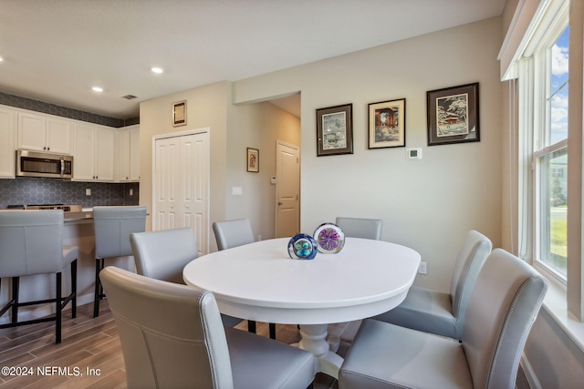 dining room with a healthy amount of sunlight and dark hardwood / wood-style floors