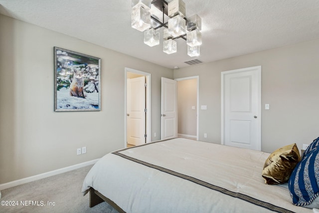 carpeted bedroom with a textured ceiling