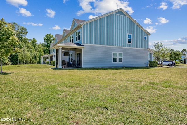 rear view of property featuring a lawn