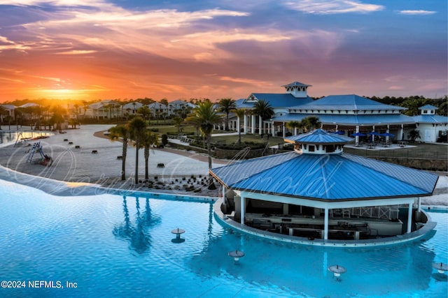 pool at dusk with pool water feature