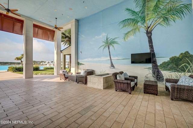 view of patio / terrace featuring ceiling fan and a water view