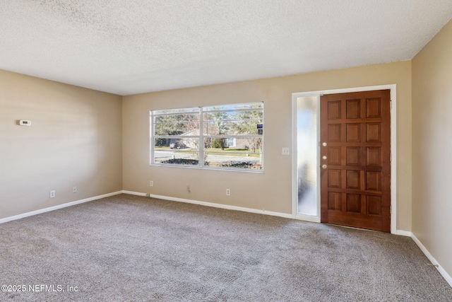 entryway with carpet and a textured ceiling