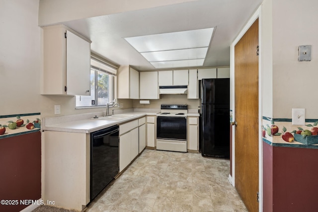 kitchen with black appliances, white cabinets, and sink