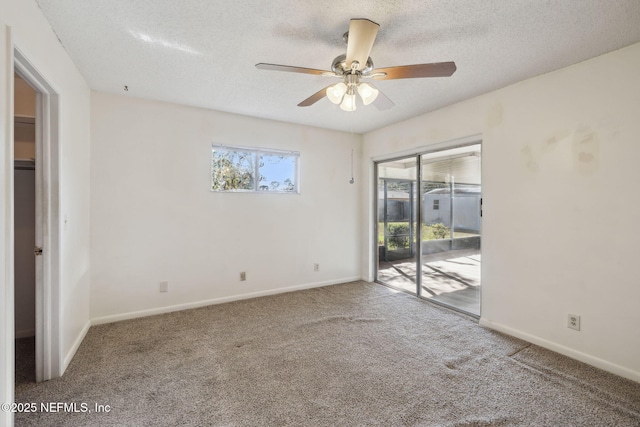 empty room featuring carpet flooring, a textured ceiling, and ceiling fan