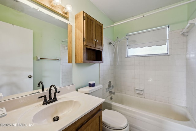 full bathroom featuring toilet, vanity, and tiled shower / bath