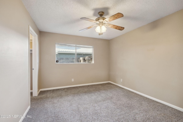 carpeted empty room with ceiling fan and a textured ceiling