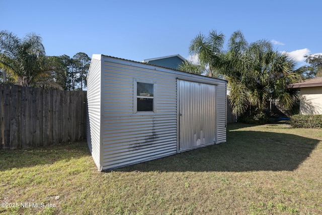 view of outbuilding featuring a lawn