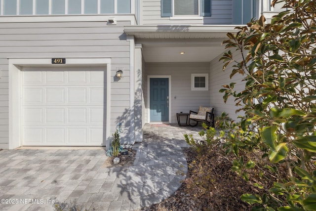 view of exterior entry with a garage