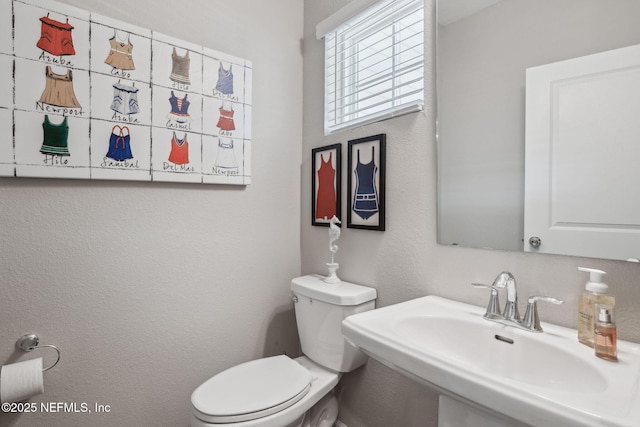 bathroom featuring sink and toilet