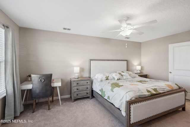 bedroom with ceiling fan and light carpet